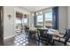Bright dining room with sliding glass doors, modern lighting, and backyard views at 15776 Native Willow Dr, Monument, CO 80132