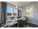 Elegant dining room featuring modern lighting, backyard views, and stylish decor at 15776 Native Willow Dr, Monument, CO 80132