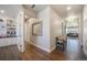 Hallway leading to an office and living room, featuring hardwood floors and decorative elements at 15776 Native Willow Dr, Monument, CO 80132