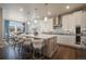 Open kitchen with a large center island, pendant lighting, modern appliances, and an adjacent dining area at 15776 Native Willow Dr, Monument, CO 80132