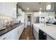Bright kitchen featuring white cabinets, stainless steel appliances, and a decorative backsplash at 15776 Native Willow Dr, Monument, CO 80132