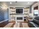 Bright living room featuring a fireplace, decorative shelves, and modern recessed lighting at 15776 Native Willow Dr, Monument, CO 80132