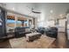 Spacious living room with stylish furniture, a ceiling fan, and an open floor plan leading to the kitchen at 15776 Native Willow Dr, Monument, CO 80132