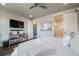Bright bedroom featuring a television and sliding door to the bathroom at 15776 Native Willow Dr, Monument, CO 80132
