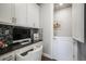 Cozy office space with custom cabinetry, stylish backsplash, and a built-in desk at 15776 Native Willow Dr, Monument, CO 80132