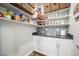 Well-organized pantry with ample shelving, cabinets, and a stylish backsplash at 15776 Native Willow Dr, Monument, CO 80132