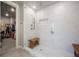 Modern glass-enclosed shower featuring a bench, sleek hardware, and contemporary finishes at 15776 Native Willow Dr, Monument, CO 80132