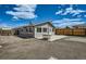 Backyard features a gravel area, patio, and updated fence at 1533 E Harlan, Lakewood, CO 80214