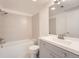 Bathroom with updated vanity, a tiled shower over tub, and a neutral color palette at 1533 E Harlan, Lakewood, CO 80214