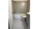 Tiled bathroom with modern shower and bath at 1533 E Harlan, Lakewood, CO 80214