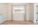 Bedroom with light wood floors, a window with natural light, and neutral walls providing a calming atmosphere at 1533 E Harlan, Lakewood, CO 80214