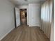 Bedroom with hardwood floors, curtains, and a view into other rooms at 1533 E Harlan, Lakewood, CO 80214