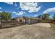 Charming home with gravel landscaping surrounding the property and a partially fenced yard at 1533 E Harlan, Lakewood, CO 80214