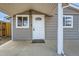 Up-close view of the front door with decorative glass, a security camera, and a 'Welcome' mat at 1533 E Harlan, Lakewood, CO 80214