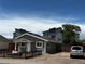 Inviting single-story residence with gray siding, a manicured yard, and convenient parking space at 1533 E Harlan, Lakewood, CO 80214