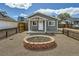 Charming home with a cozy front yard and a custom fire pit, perfect for outdoor entertaining at 1533 E Harlan, Lakewood, CO 80214