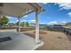 Exterior shot of the gravel front yard featuring a fire pit, quaint fence, and covered porch at 1533 E Harlan, Lakewood, CO 80214