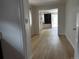 Inviting hallway featuring wood-look flooring, neutral walls, and smooth transition to other rooms at 1533 E Harlan, Lakewood, CO 80214