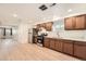 Kitchen with stainless steel appliances, wood cabinets, light countertops, and light wood floors at 1533 E Harlan, Lakewood, CO 80214