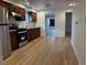 Modern kitchen with stainless steel appliances, ample counter space, and an open layout at 1533 E Harlan, Lakewood, CO 80214