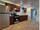 Modern kitchen with stainless steel appliances, sleek countertops, and wood-look flooring at 1533 E Harlan, Lakewood, CO 80214