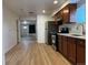 Bright, open kitchen with stainless steel appliances, dark wood cabinets, and sleek countertops at 1533 E Harlan, Lakewood, CO 80214