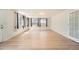Spacious living room with light wood floors and large windows offering plenty of natural light at 1533 E Harlan, Lakewood, CO 80214