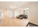 Cozy living room featuring light wood floors, large windows, and a comfortable couch and coffee table at 1533 E Harlan, Lakewood, CO 80214