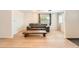 Bright living room featuring wood floors, a modern sofa, and a stylish coffee table at 1533 E Harlan, Lakewood, CO 80214