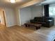 Bright living room with wood-look flooring, a comfortable seating area, and modern lighting at 1533 E Harlan, Lakewood, CO 80214