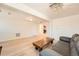 Bright living room with hardwood floors, modern lighting, and a view leading to an open kitchen area at 1533 E Harlan, Lakewood, CO 80214