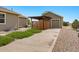 Exterior back view featuring a wooden fence, small garden and large driveway at 16231 Rayburn St, Hudson, CO 80642