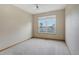 Neutral bedroom with large window providing natural light and views of the outdoors at 16231 Rayburn St, Hudson, CO 80642