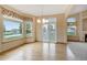 Bright dining room featuring hardwood floors, large windows, and stylish light fixture at 16231 Rayburn St, Hudson, CO 80642