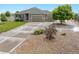 Exterior front view of a landscaped home with large driveway and mature trees at 16231 Rayburn St, Hudson, CO 80642