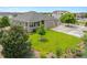 Beautifully landscaped front yard with a lush green lawn and mature trees surrounding a single-story home at 16231 Rayburn St, Hudson, CO 80642