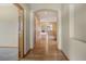 Inviting hallway with hardwood floors and arched doorways leading to the living area at 16231 Rayburn St, Hudson, CO 80642