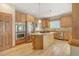 Updated kitchen with stainless steel appliances, double oven, and an island with a granite countertop at 16231 Rayburn St, Hudson, CO 80642