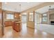 Spacious kitchen with hardwood floors, central island, granite countertops, and stainless steel appliances at 16231 Rayburn St, Hudson, CO 80642