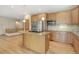 Well-lit kitchen featuring a center island, stainless steel appliances, and hardwood floors at 16231 Rayburn St, Hudson, CO 80642