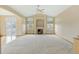 Spacious living room with vaulted ceilings, a fireplace, and large windows providing ample natural light at 16231 Rayburn St, Hudson, CO 80642
