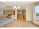 Open-concept living room with hardwood floors, recessed lighting, and access to kitchen with stainless steel appliances at 16231 Rayburn St, Hudson, CO 80642