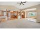 Bright, open living room that transitions to the kitchen and dining area with large windows at 16231 Rayburn St, Hudson, CO 80642