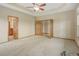 Large main bedroom featuring neutral walls, carpet, and adjoining bathroom and walk-in closets at 16231 Rayburn St, Hudson, CO 80642
