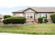 A charming backyard with lush grass, mature hedges, and a cozy patio provides great curb appeal at 6193 Terry Ct, Arvada, CO 80403
