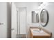 This well-lit bathroom offers a clean, classic design with a vanity, mirror, and convenient access to the toilet at 6193 Terry Ct, Arvada, CO 80403