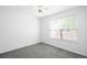 The bedroom is bright with natural light, featuring neutral carpet and a ceiling fan at 6193 Terry Ct, Arvada, CO 80403