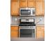 The kitchen features stainless steel appliances and oak cabinetry at 6193 Terry Ct, Arvada, CO 80403