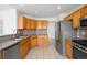 Functional kitchen with stainless steel appliances and light wood cabinets at 6193 Terry Ct, Arvada, CO 80403