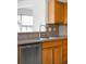 Close-up of kitchen sink, dishwasher and wood cabinets at 6193 Terry Ct, Arvada, CO 80403